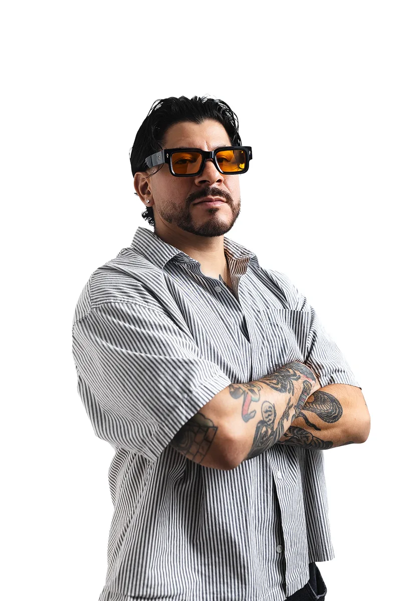 Brian Martinez, arms crossed, studio portrait