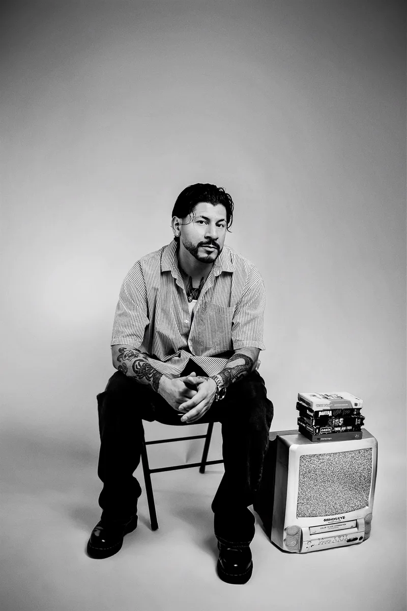 Brian seated with the CRT TV and VHS tapes