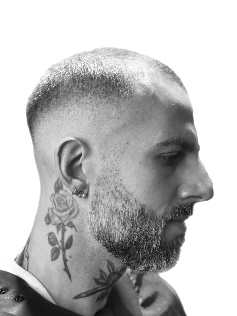 A skin fade and full beard in profile